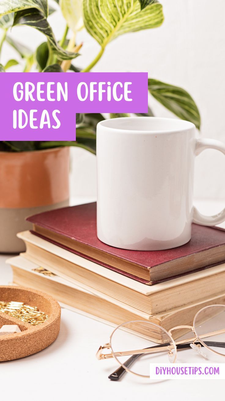 a coffee cup sitting on top of a stack of books next to glasses and a potted plant