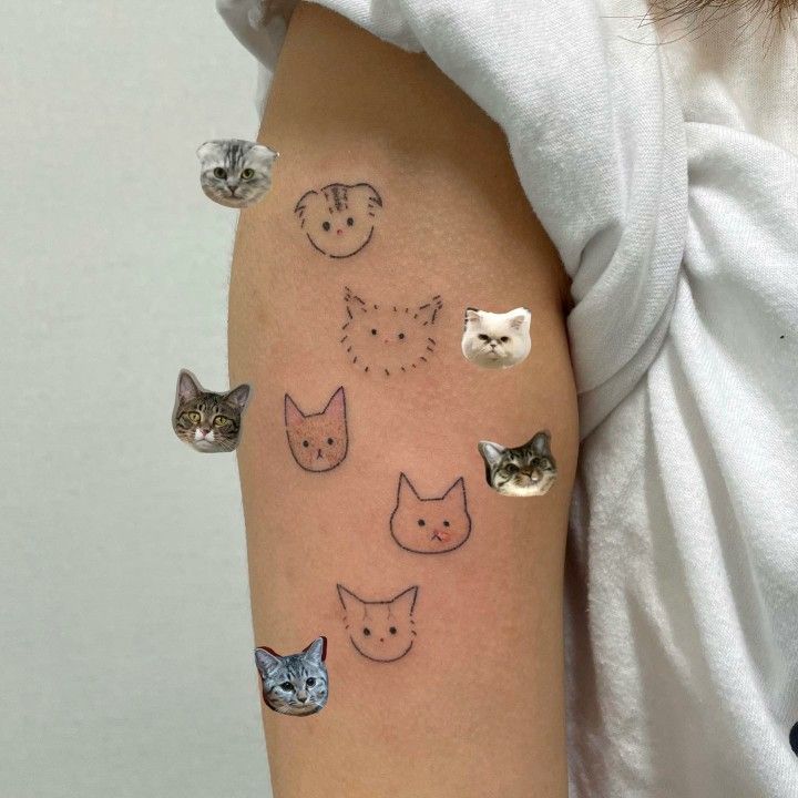 a woman's arm with cats and kittens drawn on the back of it