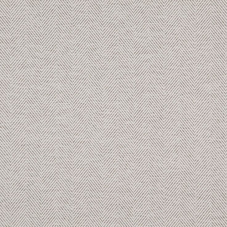 an upholstered area rug with white and grey herringbones