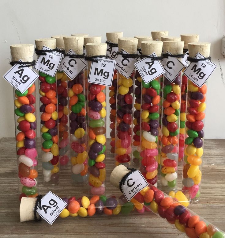 a bunch of candy sticks sitting on top of a wooden table next to each other