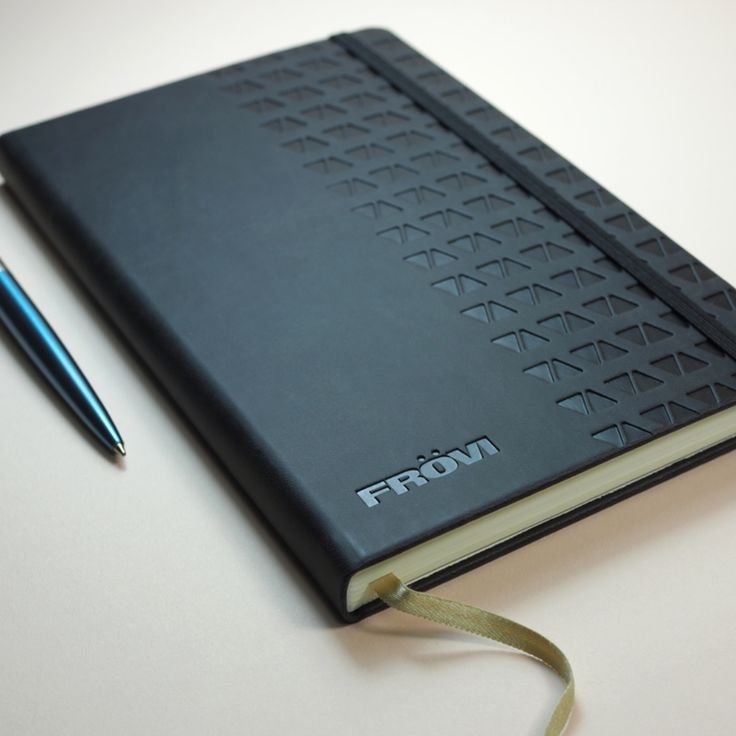 a notebook with a pen on top of it