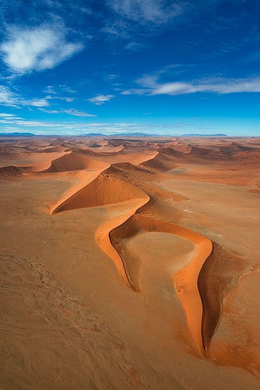 sand dunes in the desert under a blue sky