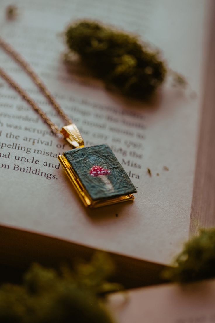 Handpainted watercolor mushroom on a gold-plated locket. Painting was painted directly onto the locket using watercolor ground and a teeeeny tiny brush. 🧵 Material: Locket and chain are gold-plated. Medium used is watercolor. ⚒️ Creation: This item has been pre-created in and is ready to ship. ♥️ Care Instructions: Remove before bathing or entering water, store in a closed bag or box. Hand Painted Brass Jewelry Gift, Hand Painted Brass Jewelry For Gifts, Locket Painting, Watercolor Ground, Watercolor Mushroom, Cottagecore Gifts, Academia Fashion, I'm Broke, Jewelry Aesthetic