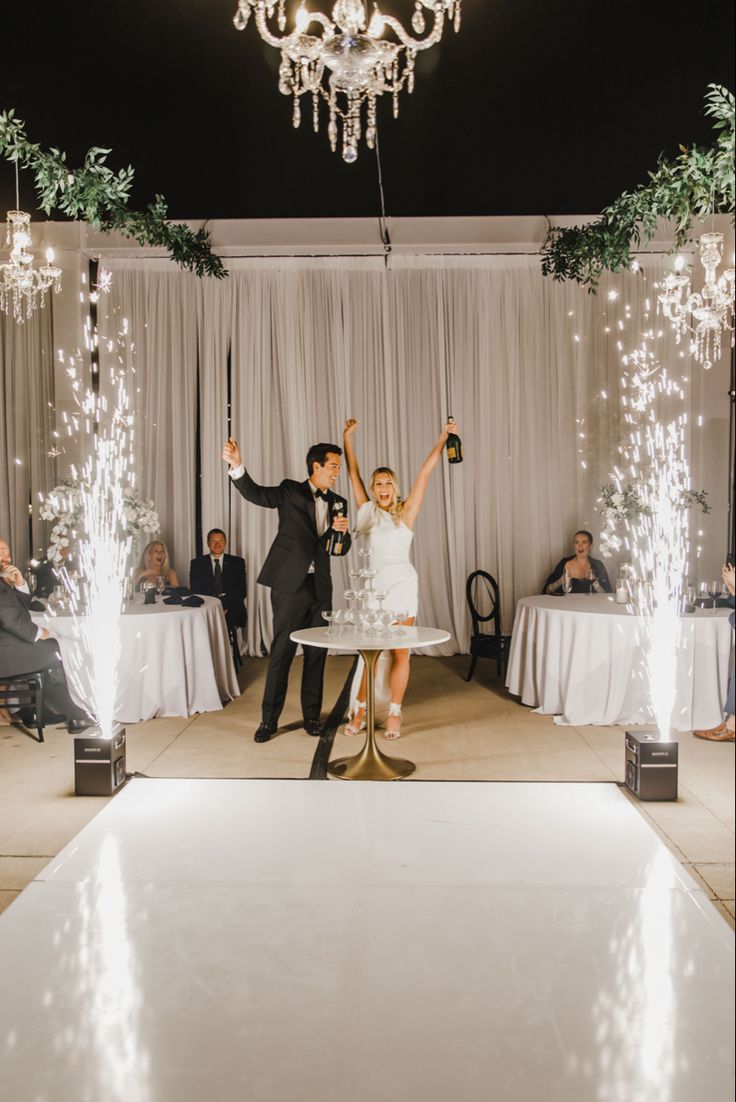 a bride and groom dancing on the dance floor at their wedding reception in front of an audience