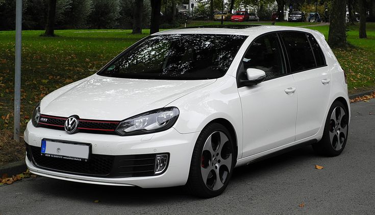 a white car is parked on the street