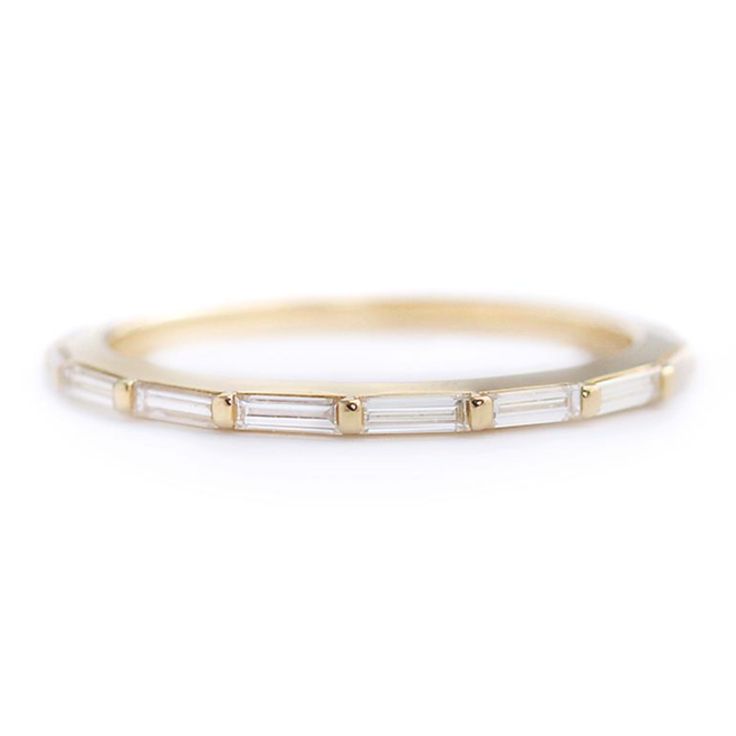 a thin gold band with baguets on the side