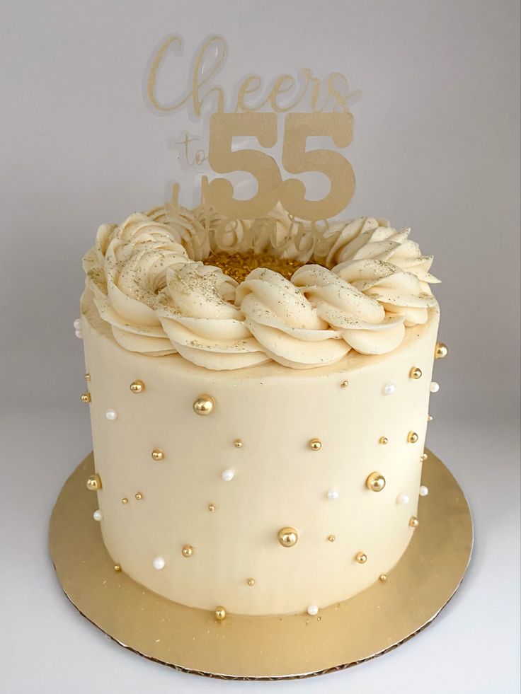 55th birthday cake with custom gold topper. Cream colored buttercream with piped ring on top, with gold sanding sugar, sprinkled with edible glitter and decorated with gold and pearl balls. Salted Caramel Birthday Cake Ideas, 50th Bday Cake For Women Elegant, Cack Decoration Easy, Gold Theme Birthday Cake, Cupcake Cake Designs Birthday, Cream Cake Design Birthday, Gold Bday Cake, Caramel Cake Design, Buttercream Cake Designs Birthday