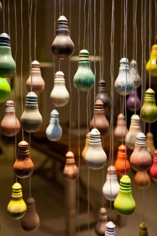 many different colored light bulbs hanging from strings