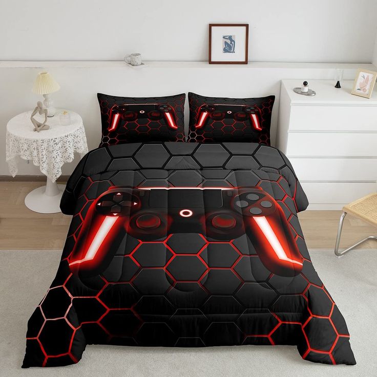 a bed with a black and red comforter set that has lights up on it