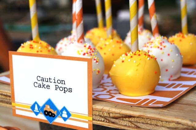 cake pops with candles are on a table