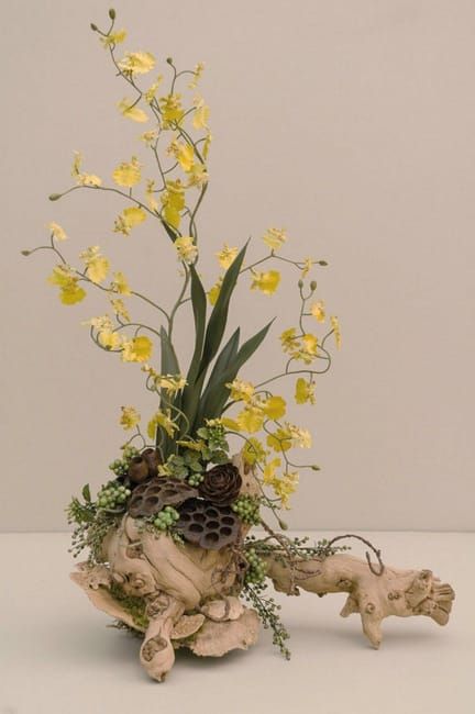 a vase filled with yellow flowers sitting on top of a table