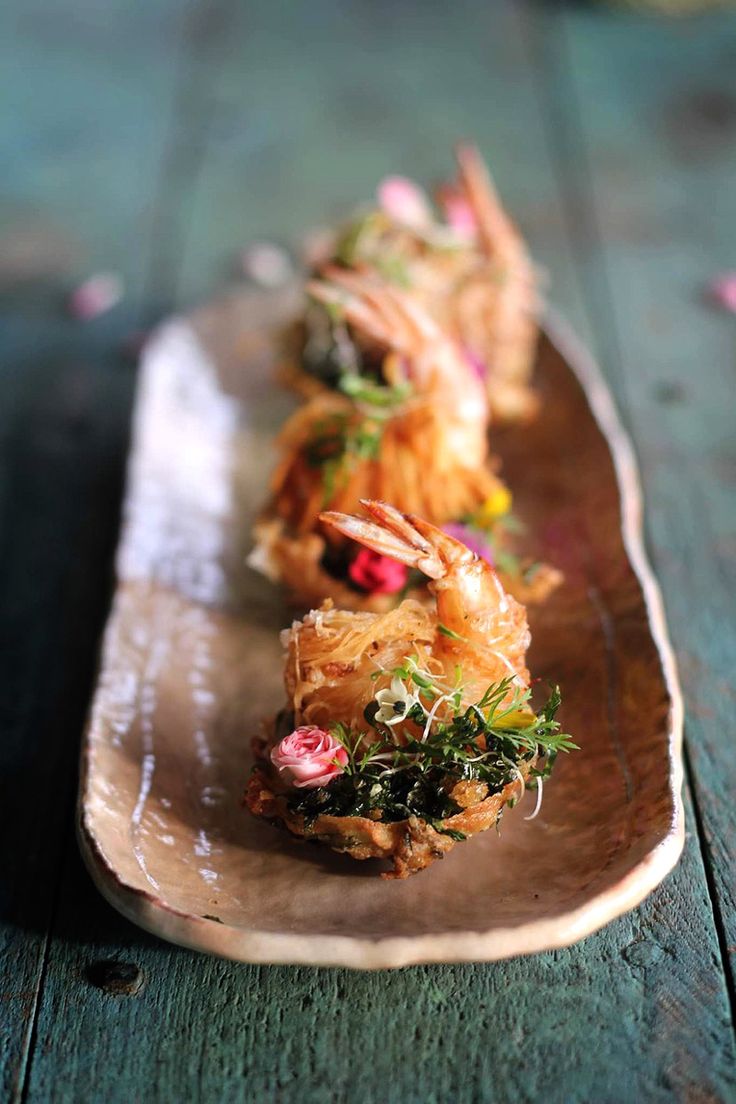 some food is sitting on a wooden plate