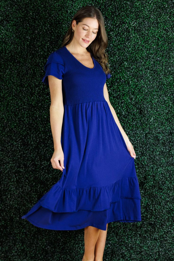 A statement dress that feels as comfortable as loungewear, sign us up! The Mattie Dress is just that and more. The smocking on the chest is so flattering and comfortable that this is going to be our go to dress for everything from vacation to date night. In a classic navy, this piece will last from season-to-season. This dress runs large, we recommend you size down. FAVORITE FEATURES: Smocked Bodice Tiered Flattering V-Neck Ruffle Sleeve Detail Midi Length Chic Maxi Length Smocked Dress For Brunch, Comfortable V-neck Dress For Spring, Spring Stretch Midi Dress For Loungewear, Casual Maxi Dress With Relaxed Fit For Day Out, Flowy Casual Dresses For Loungewear, Spring Casual Midi Dress For Loungewear, Spring Casual Midi Loungewear Dress, Midi Dress With Smocked Back And Relaxed Fit, Stretch Maxi Dress With Smocked Back