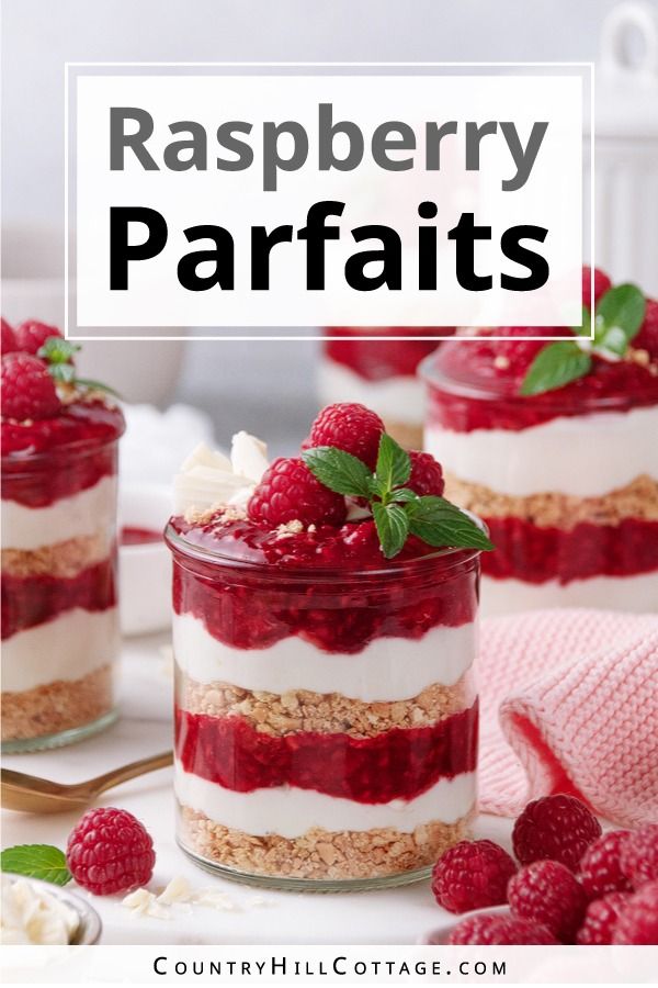 raspberry parfaits in small glass jars with berries on top