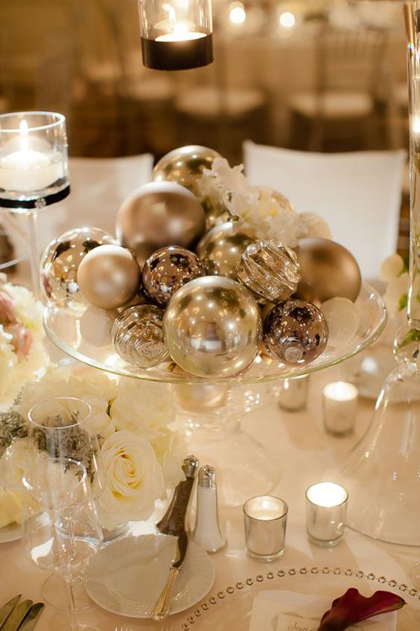 a glass bowl filled with ornaments on top of a table