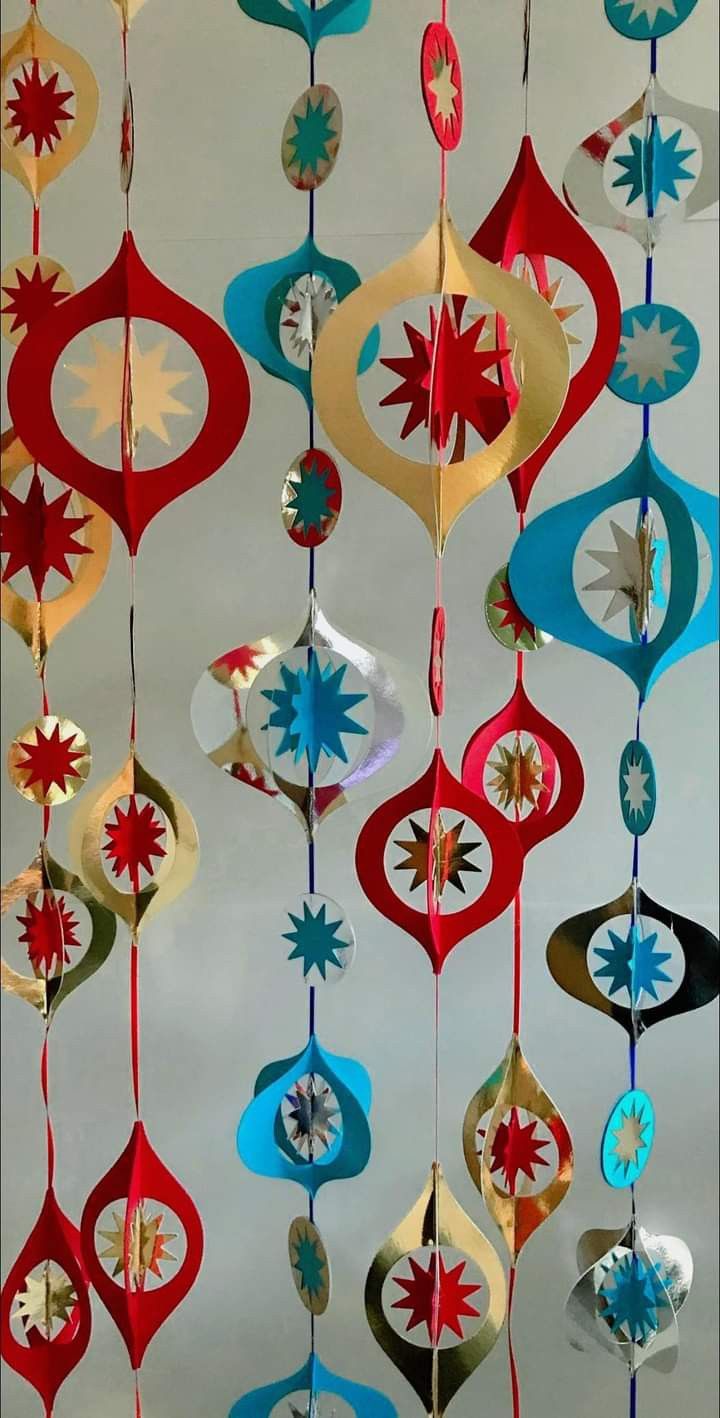 an assortment of colorful ornaments hanging from the ceiling