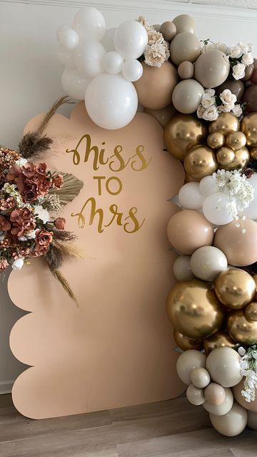 the balloon arch is decorated with gold, white and pink balloons that say miss to mrs