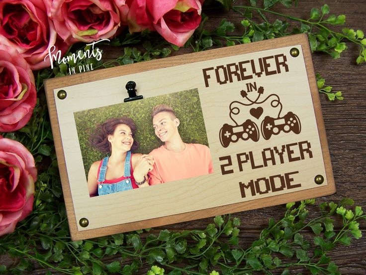 a wooden photo frame with the words forever in e - player mode on it next to flowers