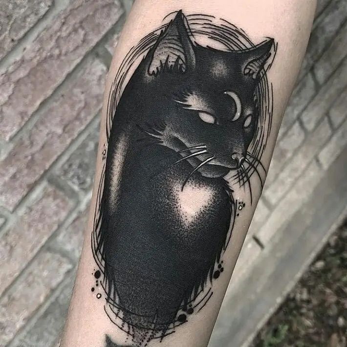 a black and white cat tattoo on the arm