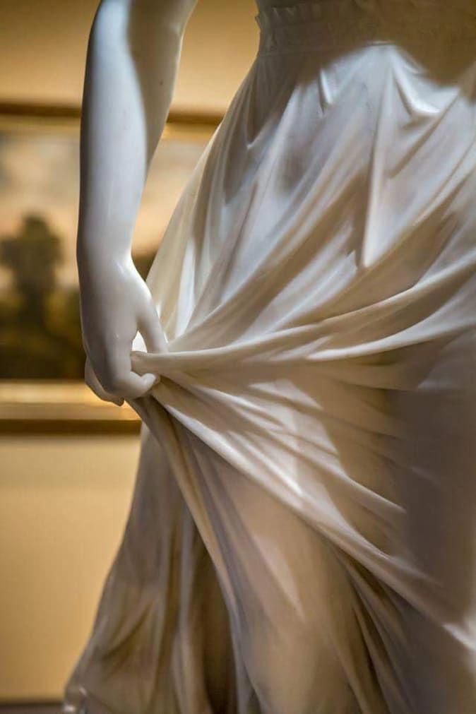 a woman's dress is draped in white fabric