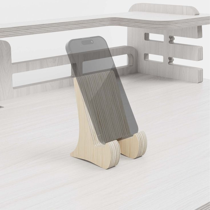 a cell phone holder sitting on top of a wooden table next to a white bench