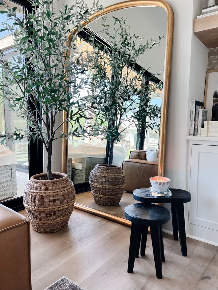 a living room filled with furniture and a large mirror