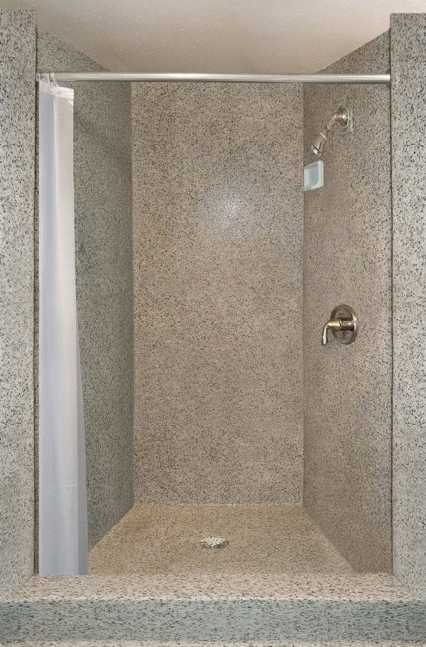 a walk in shower sitting inside of a bathroom