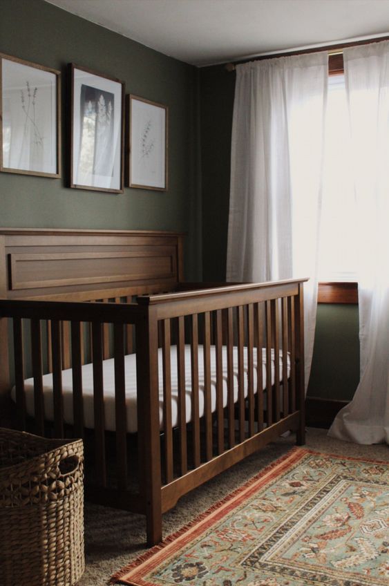 a baby crib sitting in front of a window