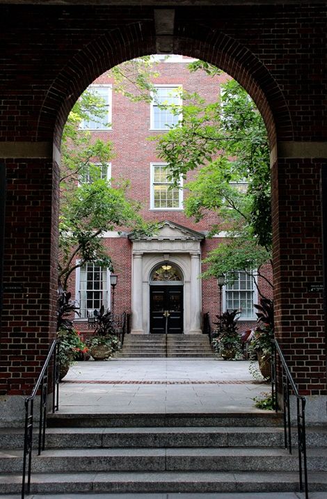 the entrance to an apartment building with steps leading up to it and trees on either side