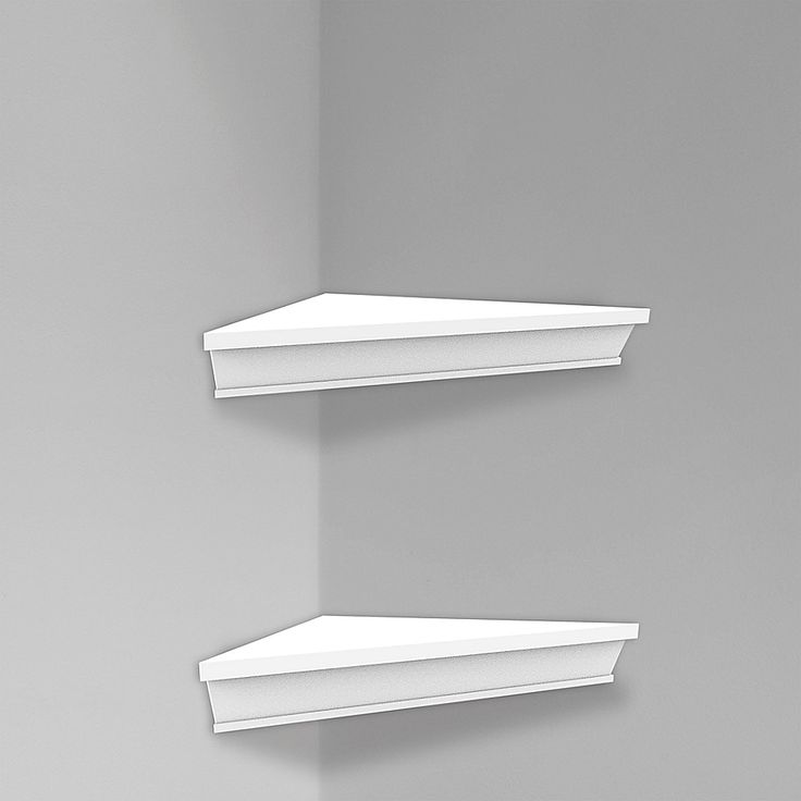 two white shelfs on the wall in a room