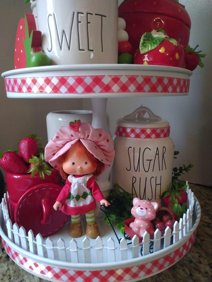 a tiered tray with strawberry shortcakes and sugar rush items