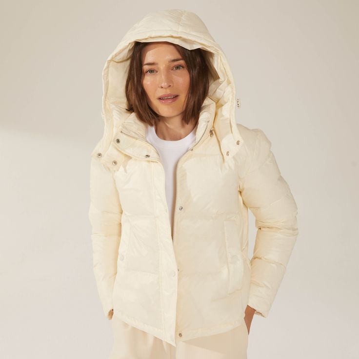 Luxuriously dense yet ultra-lightweight, this water-resistant hooded puffer jacket is a must-have for every winter wardrobe. Winter White Outerwear With Detachable Hood For Fall, Winter White Hooded Jacket With Detachable Hood For Fall, Fall Hooded Jacket With Detachable Hood In Winter White, Winter White Down Puffer Jacket For Spring, Padded Collar Hooded Jacket For Cold Weather In Spring, Spring Hooded Puffer Jacket With Padded Collar, Spring Hooded Jacket With Padded Collar For Cold Weather, Winter White Hooded Jacket With Drawstring For Fall, Winter White Outerwear With Drawstring Hood