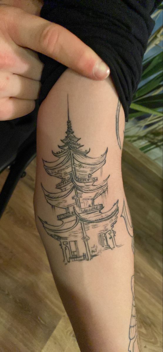 a woman's arm with a tattoo on it and a pine tree in the middle