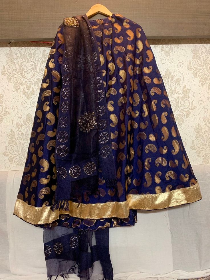 Custom made beautifull costume with 7 meters of flare skirt with zari gota border and gold detailing dupatta  It comes with golden tassels, dupatta of your choice and brocade blouse  Discuss with our designers about your dancing dress  Negotiation on price as per quantity, we offer bulk discounts for group costumes - Fine quality dark blue color banarasi brocade fabric with cotton lining inside  - brocade blouse  - any color combination can be created  - full circle skirt with flare 7 meters flare - when the dancer will spin the skirt takes full circle - get your outfit custom made with us  - leave a message to discuss - the item will be made as per your measurements  - can be created in any color Bollywood dance costume- Kalbelia dance costume- Indian dance - Pakistani dance - wedding cos Bollywood Brocade Choli With Sheer Dupatta, Bollywood Brocade Sharara With Gota Work, Party Anarkali Set With Dupatta And Long Skirt, Purple Choli With Sheer Dupatta In Chanderi, Traditional Party Skirt With Sheer Dupatta, Anarkali Choli With Long Skirt For Diwali, Purple Chanderi Choli With Sheer Dupatta, Festive Choli With Long Skirt, Festive Fitted Choli With Long Skirt