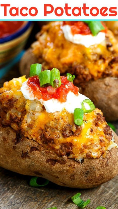 two loaded baked potatoes sitting on top of a wooden table