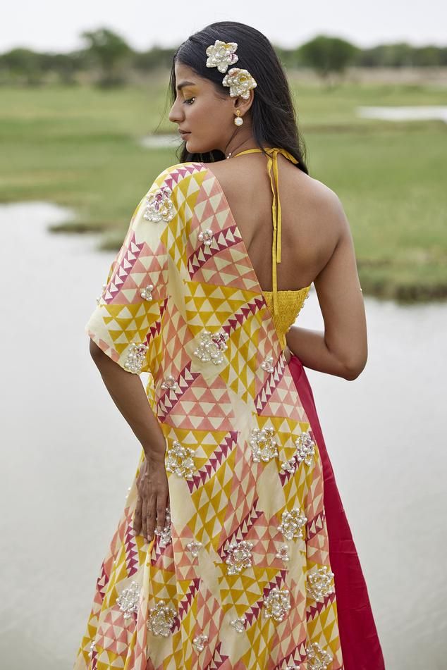 Yellow attached cancan lehenga with abstract placement print. Paired with pearl embroidered padded blouse and geometric print dupatta.
Components: 3
Pattern: Printed
Type Of Work: Abstract
Neckline: Halter neck
Sleeve Type: Sleeveless
Fabric: Taffeta
Color: Yellow
Other Details: 
Length:
Blouse: 14 inches
Lehenga: 45 inches
Model height: 5ft 8inches, wearing size S
Disclaimer: This product is exclusively hand crafted using multiple techniques, individually handled at different stages, any irregu Summer Reception Lehenga With Dupatta, Summer Lehenga With Cutdana In Saree Style, Summer Semi-stitched Pre-draped Saree For Designer Wear, Summer Reception Lehenga In Saree Style, Summer Wedding Saree Set, Summer Designer Lehenga Semi-stitched, Summer Designer Semi-stitched Lehenga, Summer Silk Lehenga With Resham Embroidery, Summer Designer Wear Pre-draped Saree With Zari Work