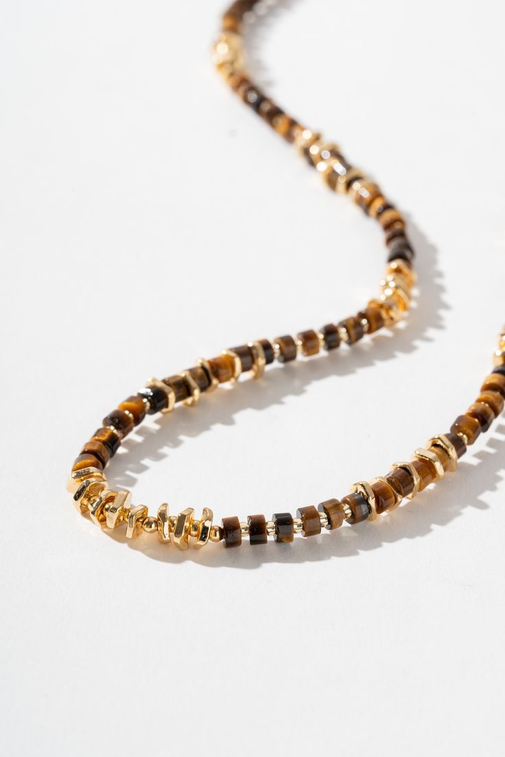 Description Introducing our exquisite handcrafted necklace, adorned with meticulously beaded Tiger's Eye stones and accented with the timeless elegance of 18k gold. Each Tiger's Eye, known for its rich hues and chatoyant brilliance, is carefully hand-beaded to create a stunning composition. The warm golden tones of the 18k gold enhance the natural beauty of the stones, adding a touch of luxury to this unique piece. Material Natural Tiger's eye Stone: a captivating gemstone known for its unique c Artisan Gold Necklace With Beaded Chain, Elegant Gold Necklace With Oval Beads, Elegant Necklaces With Oval Gold Beads, Elegant Gold Beaded Necklaces With Gemstone, Elegant Gold Beaded Necklace With Gemstones, Gold Rondelle Beaded Necklace For Gift, Luxury Beaded Necklaces With Gemstone Beads, Artisan Gold Beads Jewelry For Gift, Elegant Yellow Gold Beaded Bracelets With Gemstones