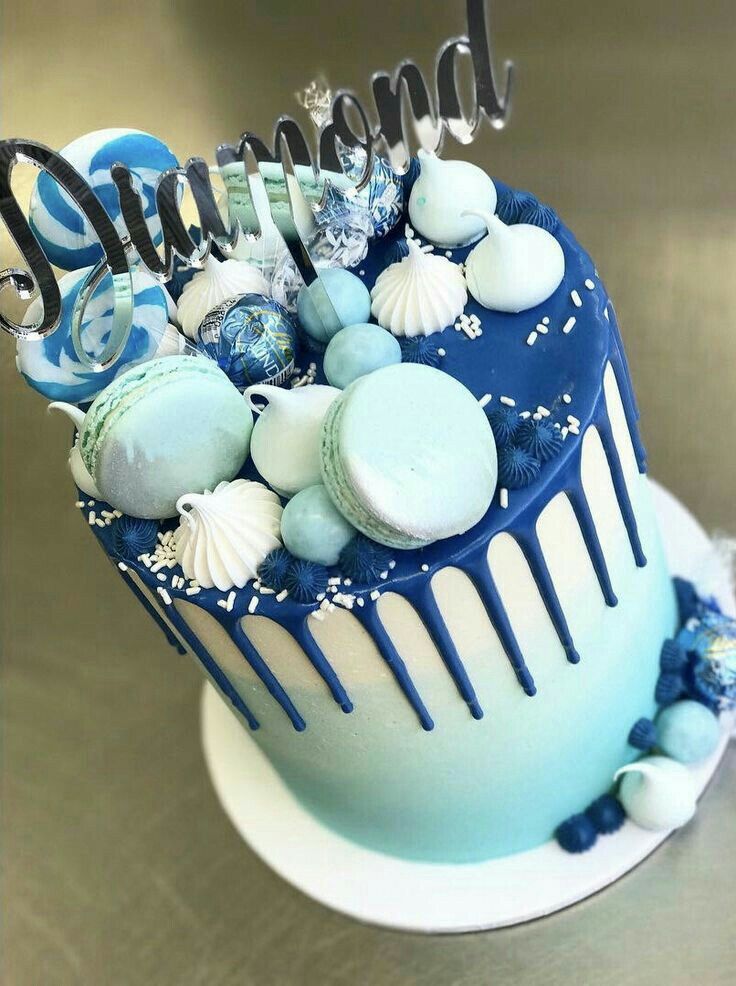 a blue and white cake decorated with sea shells