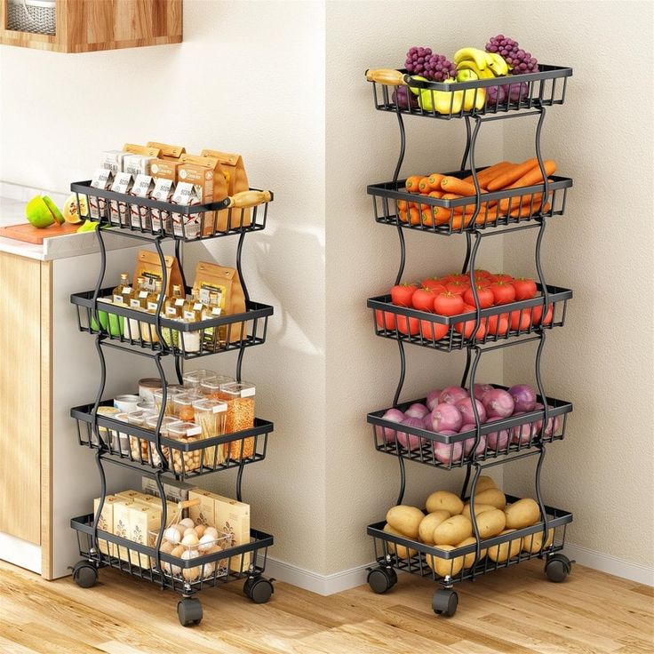 two metal racks with food on them next to each other in a kitchen, against a white wall