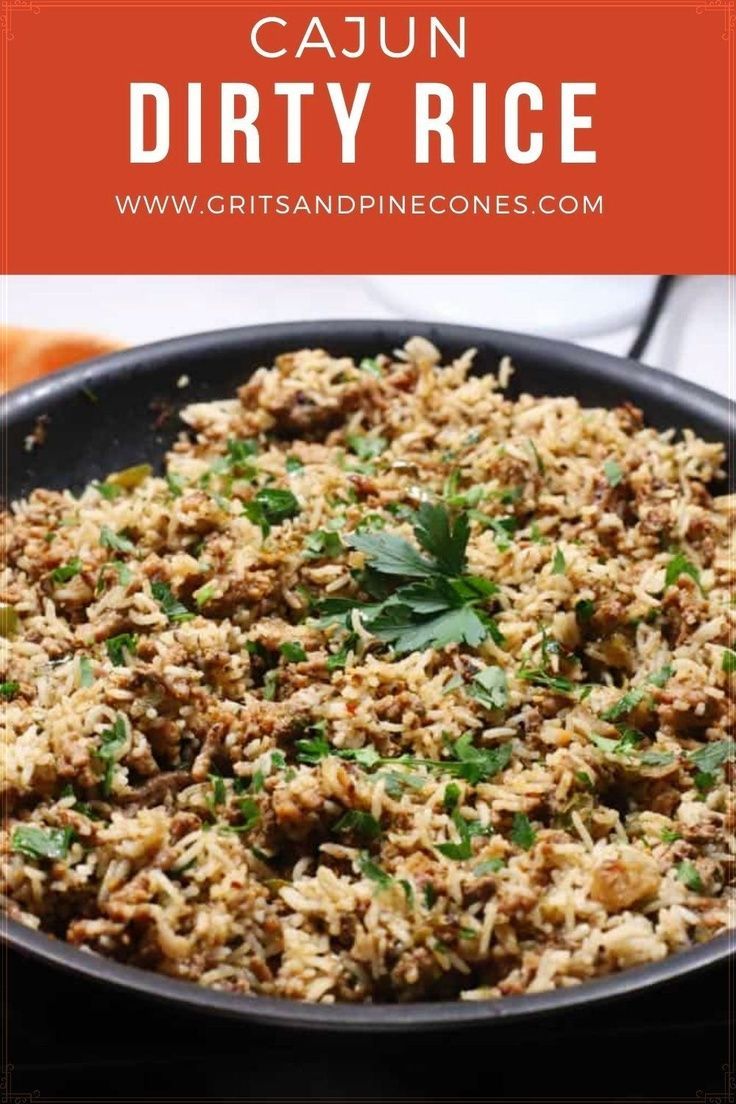 a skillet filled with cajun dirty rice and garnished with cilantro