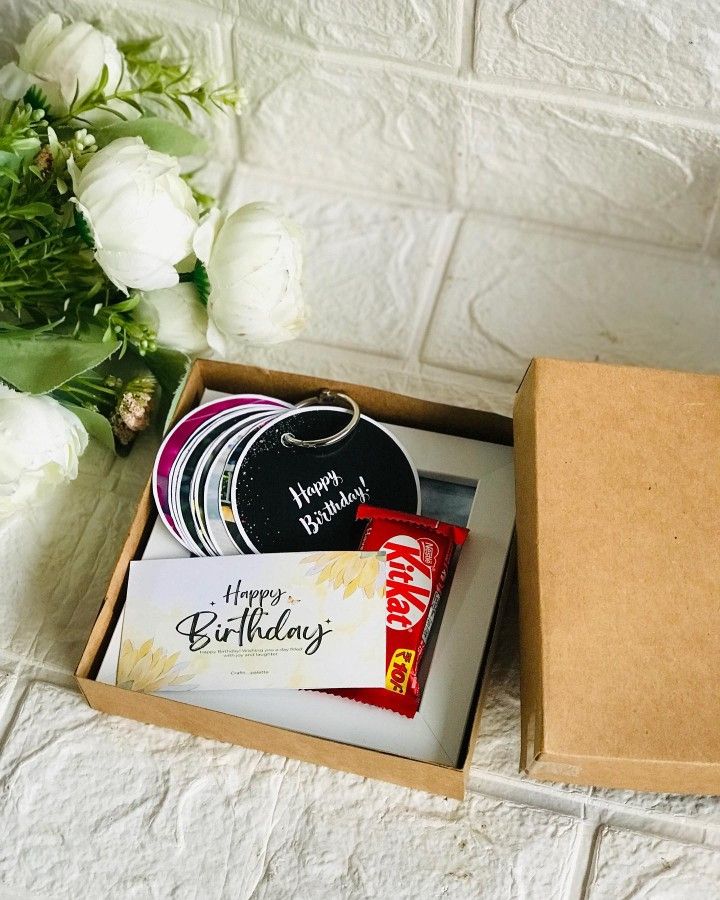 a birthday gift box with flowers and chocolates