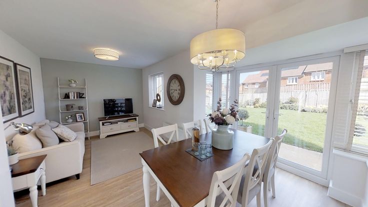 a dining room table and chairs in front of sliding glass doors