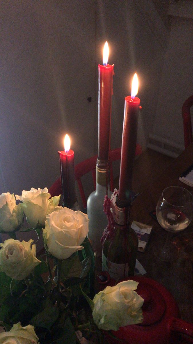 roses and candles are sitting on a table