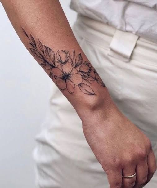 a person with a flower tattoo on their arm