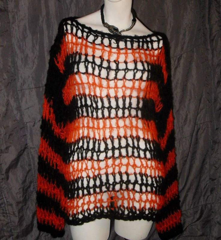 an orange and black knitted sweater on a mannequin