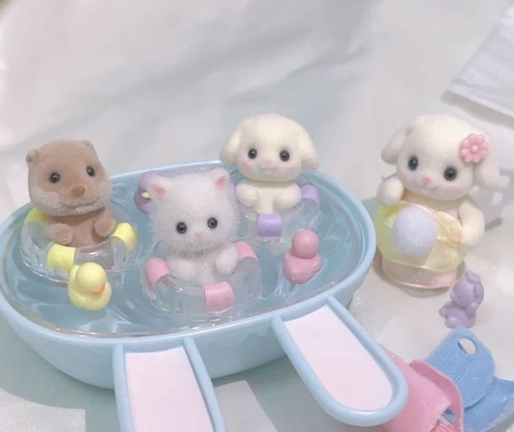 small toy animals are sitting in a bowl