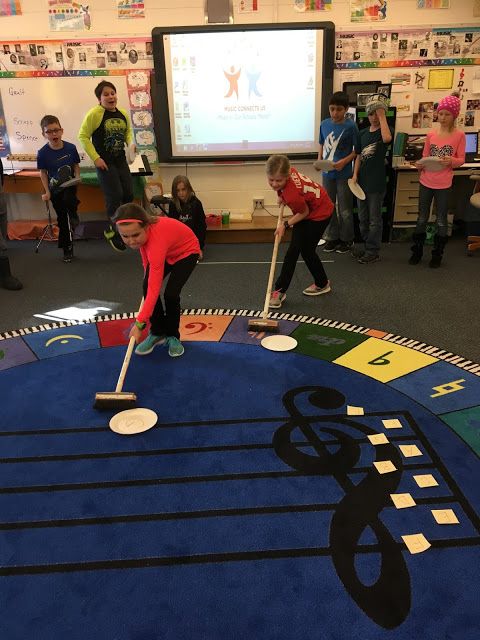 children playing with musical instruments in a classroom