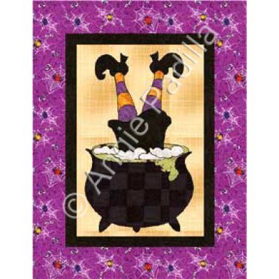 a purple and black quilt with an image of a witches caulder on it