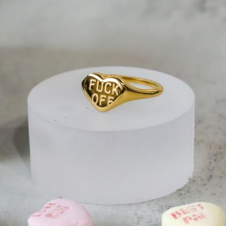 Express yourself with the F*** OFF Heart Ring! This playful accessory serves as a personal mantra, allowing you to subtly express yourself and your unique personality. Wear it with confidence and let it serve as a reminder to stay true to yourself. Material: Stainless Steel Plating: 18k real gold Ring is 100% nickel-free and cadmium-free Ring is tarnish resistant and hypoallergenic Personal Mantra, Stay True To Yourself, F Off, True To Yourself, Small Boutique, Jewelry Studio, Stay True, Be True To Yourself, Boutique Jewelry