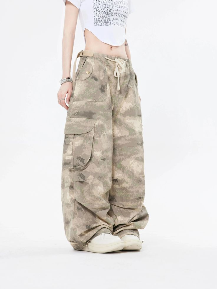 Embrace the street aesthetic with our Faded Baggy Camo Cargo Pants, perfect for making a statement while on the move.
Designed with a natural waist, these cargo pants offer a blend of comfort and durability. The camouflage pattern adds an edgy touch, while the drawstring and convenient pockets provide functionality and ease. The relaxed wide-leg silhouette ensures a nonchalant yet purposeful style, tailored for the contemporary wardrobe.
Pair them with a cropped hoodie and sneakers for running e Baggy Drawstring Parachute Pants, Baggy Full-length Parachute Pants With Drawstring, Wide Leg Streetwear Pants With Drawstring, Streetwear Full-length Drawstring Pants, Relaxed Fit Wide Leg Cargo Jeans For Outdoor, Wide Leg Pants With Drawstring For Streetwear, Combat Style Baggy Wide Leg Bottoms, Combat Style Summer Cargo Pants With Pockets, Combat Style Cargo Pants With Pockets For Summer